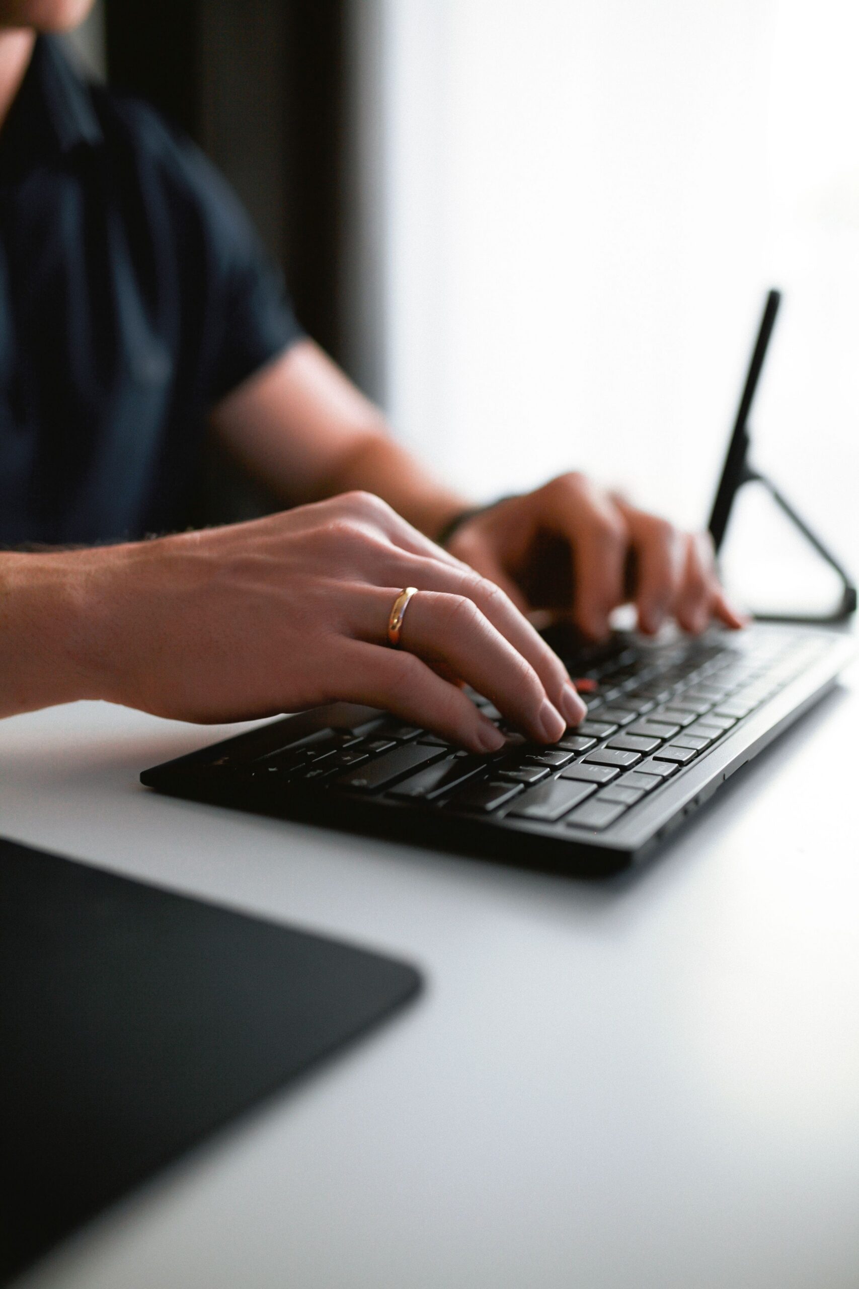 person using calculator at desk with coffee mug