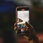 A person taking a picture with a cell phone