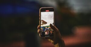 A person taking a picture with a cell phone