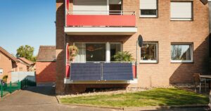 Balcony with solar panels on brick building