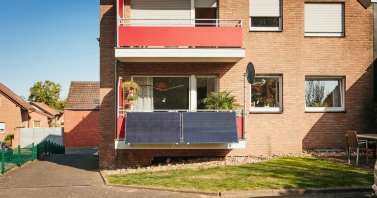 Balcony with solar panels on brick building